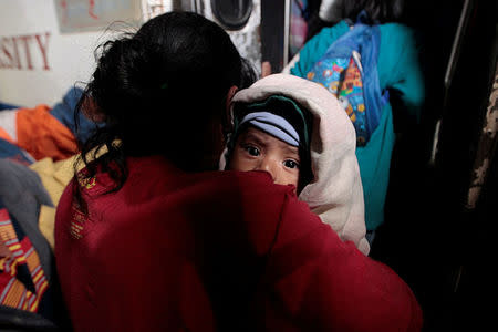 An indigenous woman and her son who were evacuated from their home arrive at the Bluefields Port before the arrival of hurricane Otto in Bluefields, Nicaragua November 23, 2016. REUTERS/Oswaldo Rivas