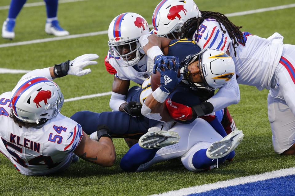 Chargers running back Austin Ekeler (30) is tackled by Buffalo Bills defense short of the goal line.