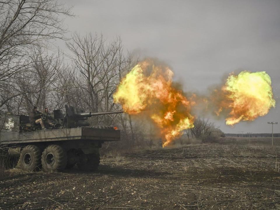Ukrainian troops fire a S60 anti-aircraft gun in Bakhmut