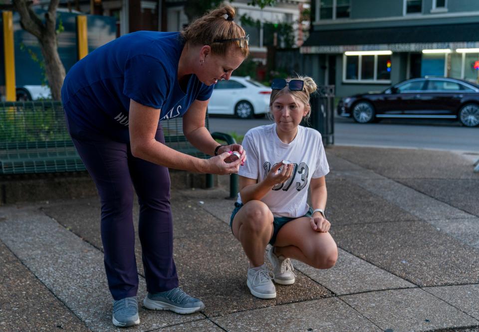 Christine Barnhart, left, and Raegan Burkes light candles during a vigil for abortion rights in Indiana in Evansville, Ind., Tuesday, Aug. 1, 2023.