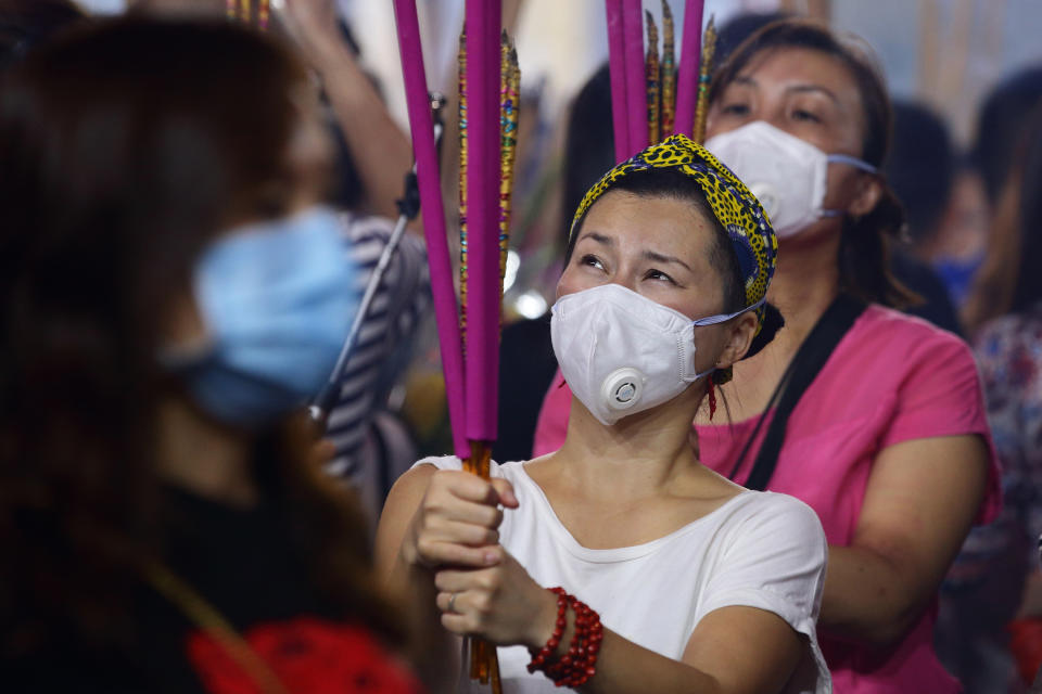 SINGAPORE - JANUARY 24:  Worshippers wearing mask, gather to pray at the Kwan Im Thong Hood Cho Temple on January 24, 2020 in Singapore. Singapore confirmed another two cases of the Wuhan viruses today, making a total of three, as Singapore prepares to usher in the Year of the Rat, one of the most anticipated holidays on the Chinese calendar. Also known as the Spring festival or the Lunar New Year, the celebrations last for about 15 days.  (Photo by Suhaimi Abdullah/Getty Images)