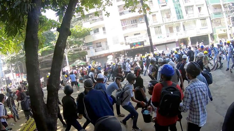 A-point-of-view from a volunteer medic running away with demonstrators from bullets, in Yangon