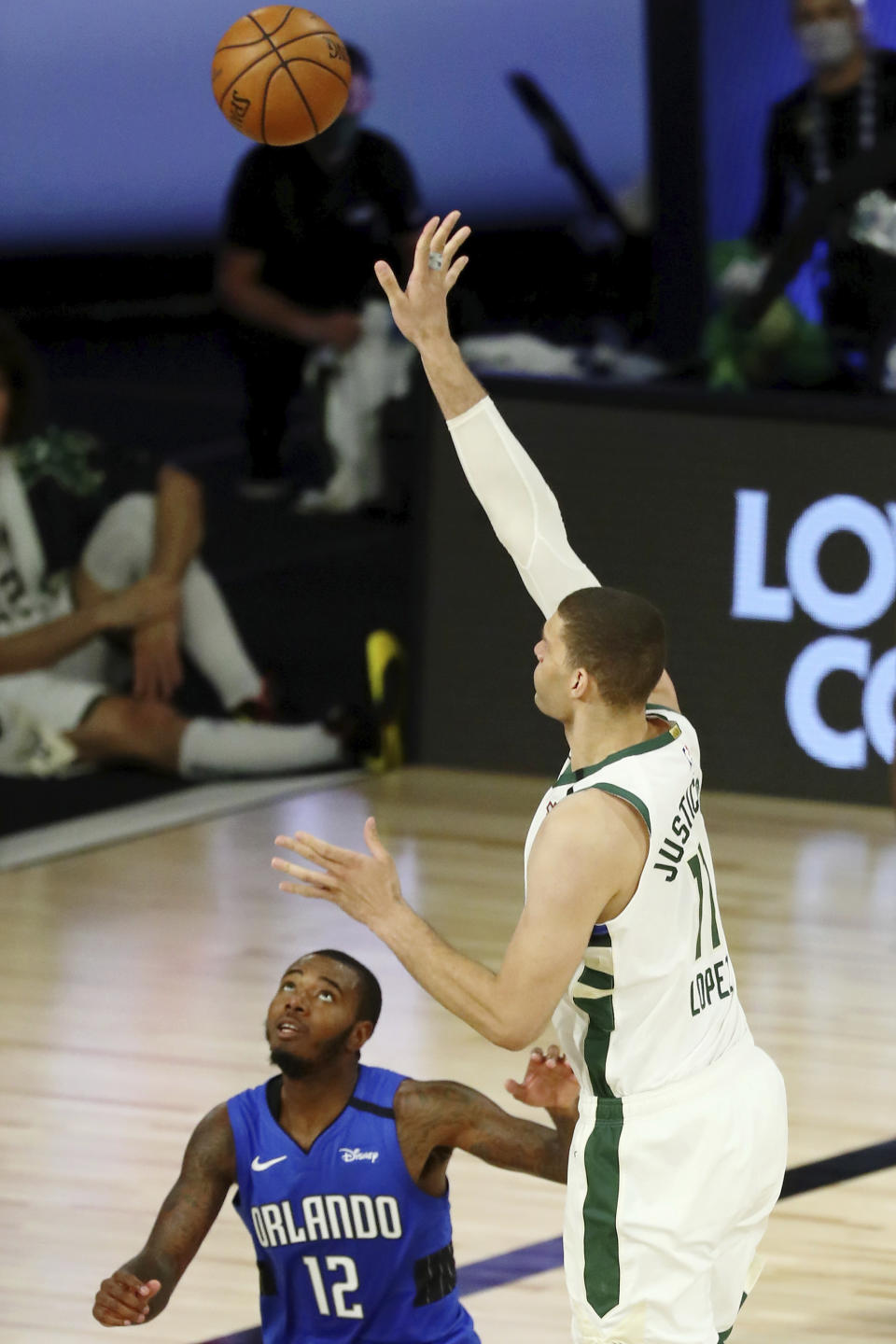 Milwaukee Bucks center Brook Lopez (11) shoots in front of Orlando Magic forward Gary Clark (12) during the second half of Game 1 of an NBA basketball first-round playoff series, Tuesday, Aug. 18, 2020, in Lake Buena Vista, Fla. (Kim Klement/Pool Photo via AP)