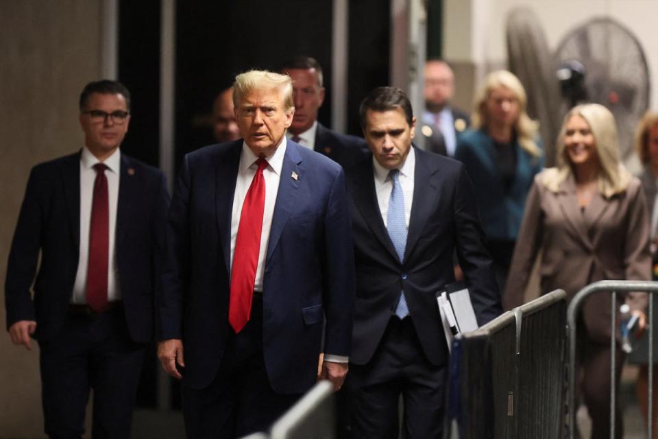 Donald Trump walks with his attorney Todd Blance, right, in a hallway outside a criminal courtroom in Manhattan on April 23.  (CHARACTERISTICS)