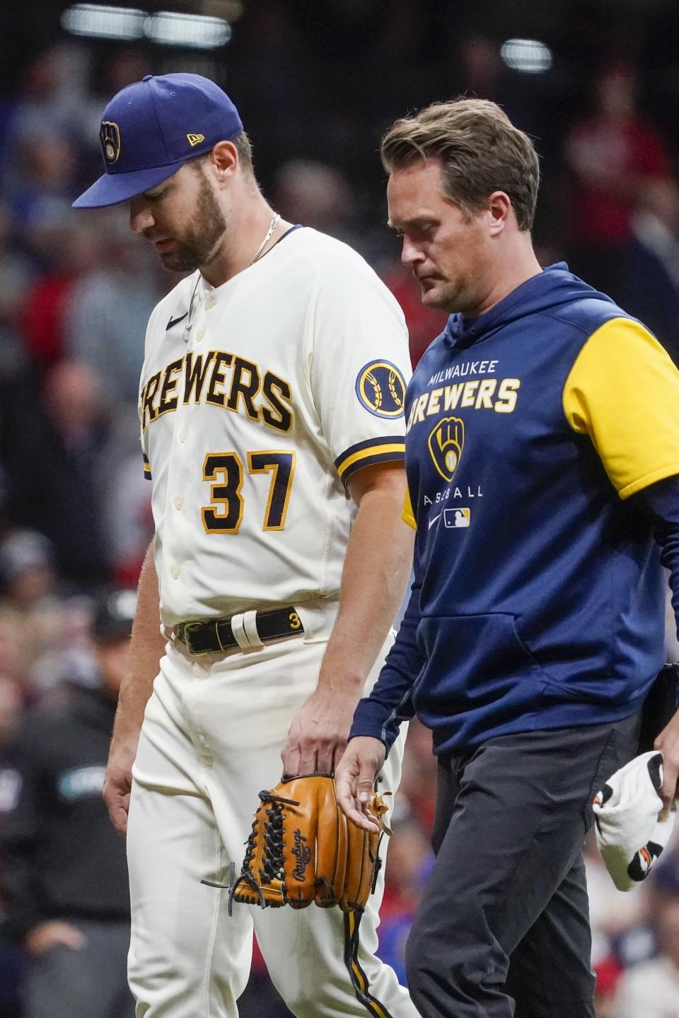 Milwaukee Brewers starting pitcher Adrian Houser leaves the game with an injury during the fourth inning of a baseball game against the St. Louis Cardinals Tuesday, Sept. 27, 2022, in Milwaukee. (AP Photo/Morry Gash)