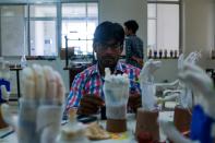 In this photograph taken on June 13, 2017, a technician adds a battery to prosthetic hands at the Bhagwan Mahaveer Viklang Sahayata Samiti non-profit organisation's main branch in Jaipur