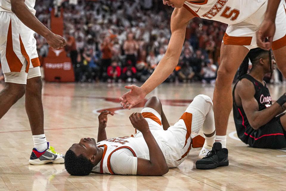 Texas guard Max Abmas lies on the court after being fouled during Monday night's 76-72 overtime loss to No. 4 Houston at Moody Center.