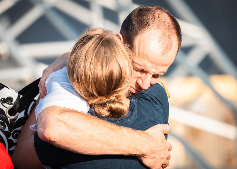 Loved ones share a moment of hugs before leaving Naval Station Mayport on planned deployment.