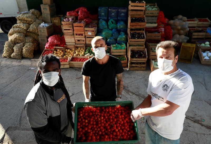 Former Brazil's head soccer coach Dunga, Internacional's soccer club player D'Alessandro and former soccer player Tinga help with food distribution to poor people, amid the coronavirus disease (COVID-19) outbreak, in Porto Alegre