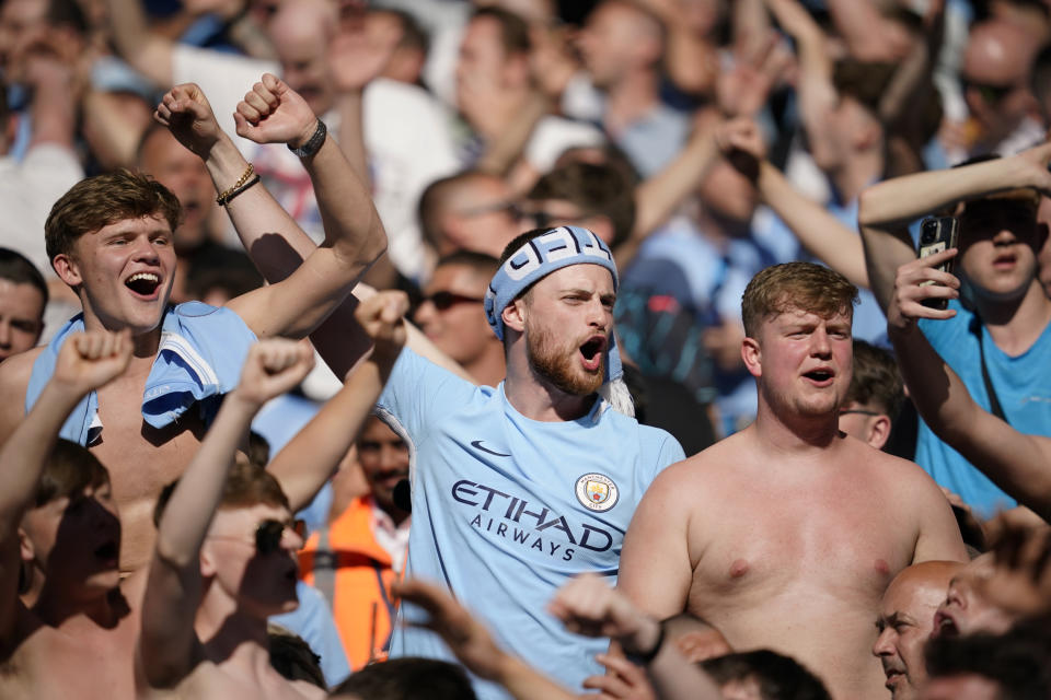 Manchester City fans celebrate after Manchester City's Rodrigo scores his side's third goal during the English Premier League soccer match between Manchester City and West Ham United at the Etihad Stadium in Manchester, England, Sunday, May 19, 2024. (AP Photo/Dave Thompson)