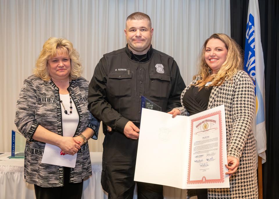 Molly Luempert Coy, left, stands with Law Enforcement Hero Officer Mike Norman and Ashleigh Glass.