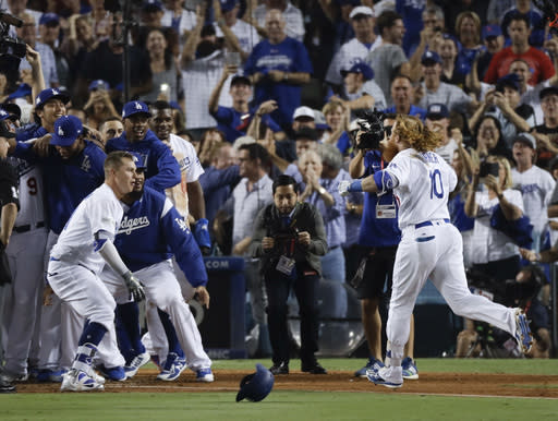 The Dodgers’ Justin Turner celebrates after a three-run, walk-off homer against the Cubs in the ninth inning Sunday. (AP)