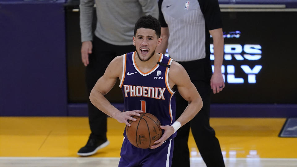 Phoenix Suns guard Devin Booker (1) controls the ball during Game 6 of an NBA basketball first-round playoff series against the Los Angeles Lakers Thursday, Jun 3, 2021, in Los Angeles. (AP Photo/Ashley Landis)