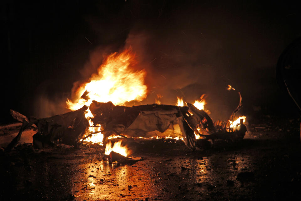 Cars burn after one of two car bombs, in Mogadishu, Somalia, Sunday Aug. 5, 2018. Two car bombs hit Somalia on Sunday, killing at least six people. Somalia's Islamic extremist rebels claimed responsibility for the first suicide car bomb blast that that killed four people when it exploded near the gate of a military base in Afgoye town, 30 kilometers (18 miles) northwest of Mogadishu. (AP Photo/Farah Abdi Warsameh)
