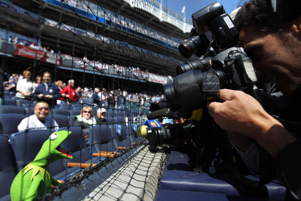 NEW YORK, NY - APRIL 13: Members of the media take the photograpn of Kermit the Frog during the New York Yankees home opener against the Los Angeles Angels at Yankee Stadium on April 13, 2012 in the Bronx borough of New York City. (Photo by Nick Laham/Getty Images)