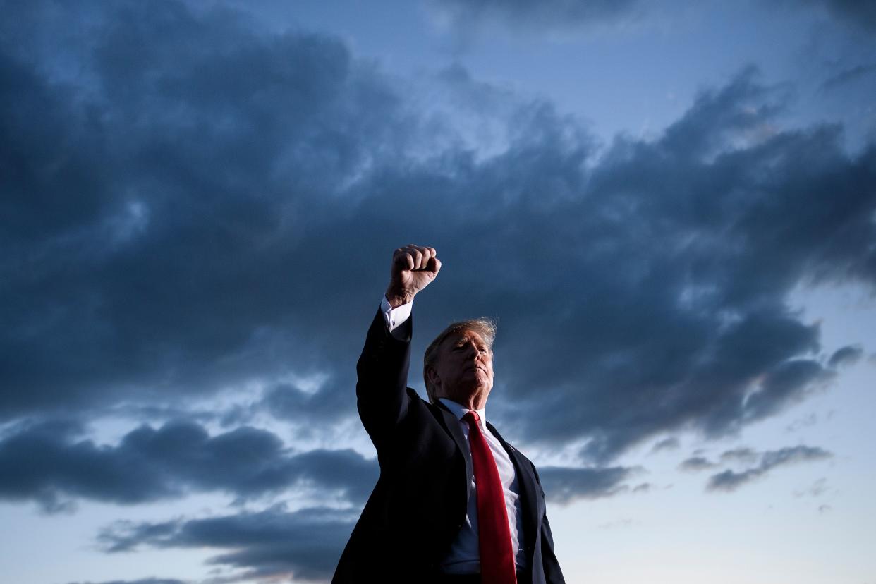 President Trump holds up his fist as he leaves a rally in Montoursville, Pa, in May. (Photo by Brendan Smialowski/AFP/Getty Images)