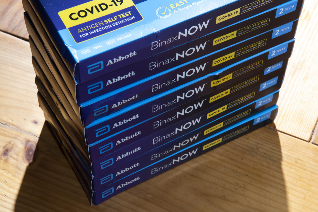 A stack of BinaxNow COVID-19 test kits.