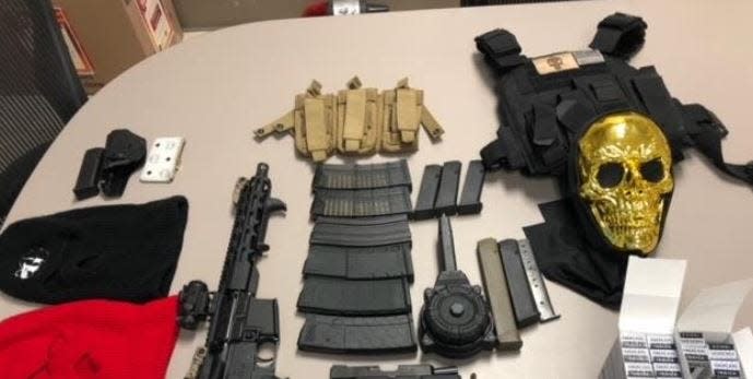 Collier County Sheriff's Office reported that deputies confiscated a number of items Sunday night, Oct. 23, 2022, after making a traffic stop. Items included: a short barrel AR-15 rifle, three loaded handguns, 16 magazines to include high-capacity mags and a drum and hollow point bullets, hundreds of rounds of ammunition, two ballistic armor vests, ski masks,  a black and gold skull full fac22e masks, vape pens and THC oil and marijuana. They arrested two of four men in the car.