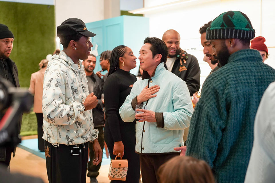 Tyler, the Creator chats with Steven Yeun at a party to celebrate the launch of his Louis Vuitton capsule collection at the Beverly Hills store on March 21, 2024.