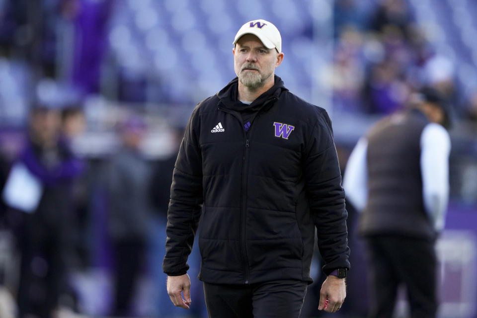 FILE - Washington offensive coordinator Ryan Grubb walks on the field before an NCAA college football game against Washington State, Nov. 25, 2023, in Seattle. Kalen DeBoer has made a rapid rise through the coaching ranks. He won three NAIA national championships as head coach at the University of Sioux Falls from 2005-09 and had five coaching stops in 12 years before landing at Washington. His offensive coordinator, Grubb, and defensive coordinator, Chuck Morrell, were on his staff at Sioux Falls (AP Photo/Lindsey Wasson, File)