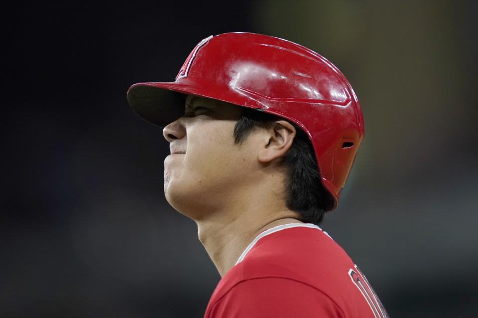 Los Angeles Angels' Shohei Ohtani walks to the bag after running through the bag on a single in the sixth inning of a baseball game against the Texas Rangers in Arlington, Texas, Wednesday, Sept. 29, 2021. (AP Photo/Tony Gutierrez)