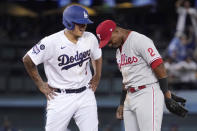 Los Angeles Dodgers' Julio Urias, left, chats with Philadelphia Phillies second baseman Jean Segura after hitting an RBI ground-rule double during the fourth inning of a baseball game Tuesday, June 15, 2021, in Los Angeles. (AP Photo/Mark J. Terrill)