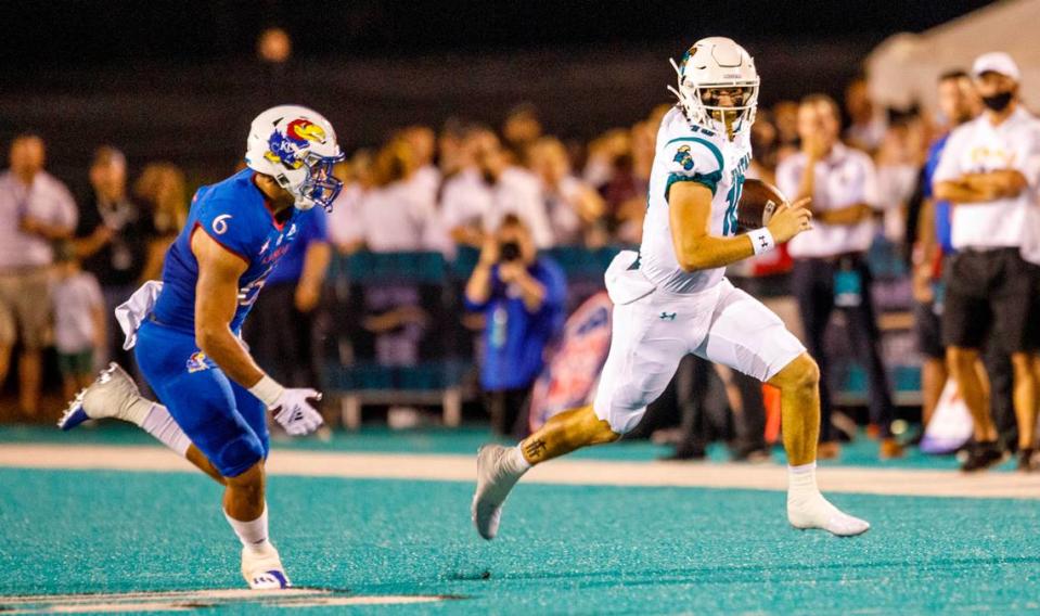 Coastal’s Grayson McCall keeps the ball to rush against Kansas. The Coastal Carolina Chanticleers hosted Kansas at Brooks Stadium Friday night. Aug. 11, 2021.