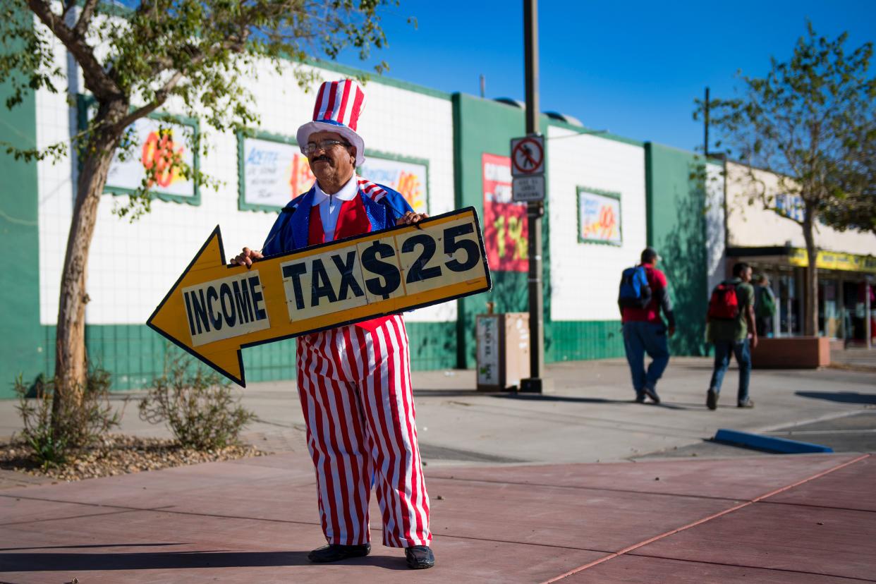 Jose (only first name given) advertises for a income tax shop dress as Uncle Sam on a corner in San Luis, Arizona, on February 15, 2017 near the US/Mexico border.
Attention Editors, this image is part of an ongoing AFP photo project documenting the life on the two sides of the US/Mexico border simultaneously by two photographers traveling for ten days from California to Texas on the US side and from Baja California to Tamaulipas on the Mexican side between February 13 and 22, 2017. You can find all the images with the keyword : BORDERPROJECT2017 on our wire and on www.afpforum.com / AFP / JIM WATSON        (Photo credit should read JIM WATSON/AFP via Getty Images)