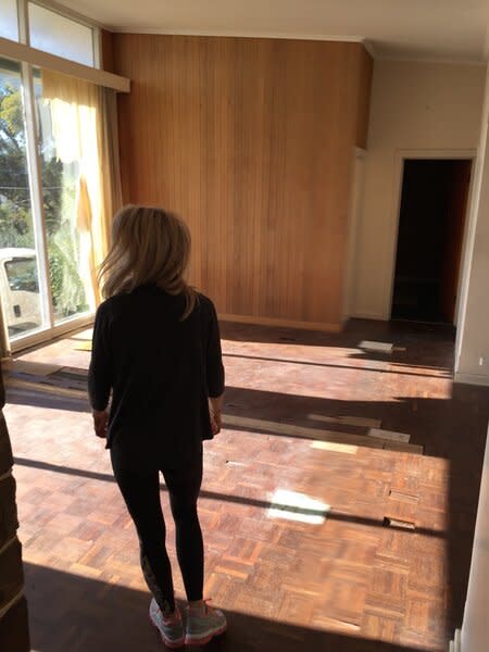 Before: The living room enjoyed plenty of natural light and had a feature timber wall.