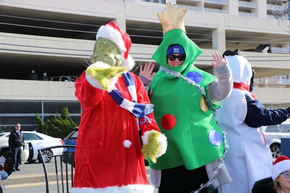 The Grinch rides up Coastal Highway waving to children during Ocean City's annual Christmas parade on Dec. 7, 2019.