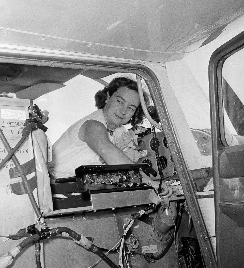 FILE - This photo made April 16, 1964, shows Jerrie Mock checking her extra gas tank cap just before taking off from Oakland Airport, in Oakland, California. Fifty years ago the 38-year-old Columbus, Ohio, housewife became the first woman to fly solo around the world. (AP Photo/Robert W. Klein)