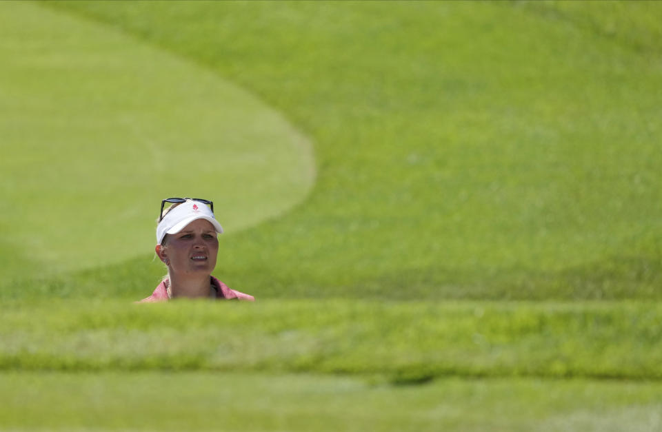 Nanna Koerstz Madsen, of Denmark, studies her shot from a bunker on the 9th green during the second round of the women's golf event at the 2020 Summer Olympics, Thursday, Aug. 5, 2021, at the Kasumigaseki Country Club in Kawagoe, Japan. (AP Photo/Andy Wong)