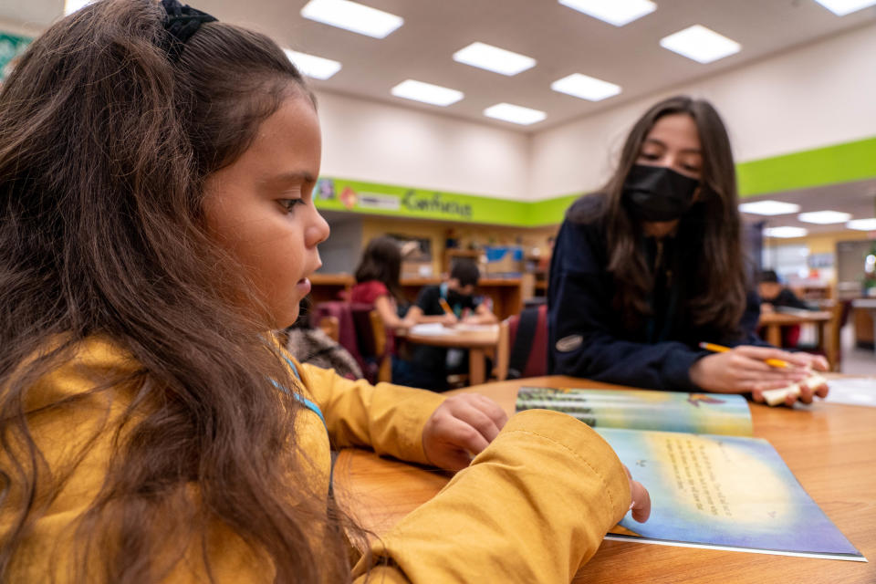 Joseline Zepeda-Lopez, 8, a third-grader, (left) and Luvina Munoz, 11, a sixth-grader, (right) read during a session with Read Better Be Better at Canyon Breeze Elementary School in Avondale on Nov. 10, 2022.