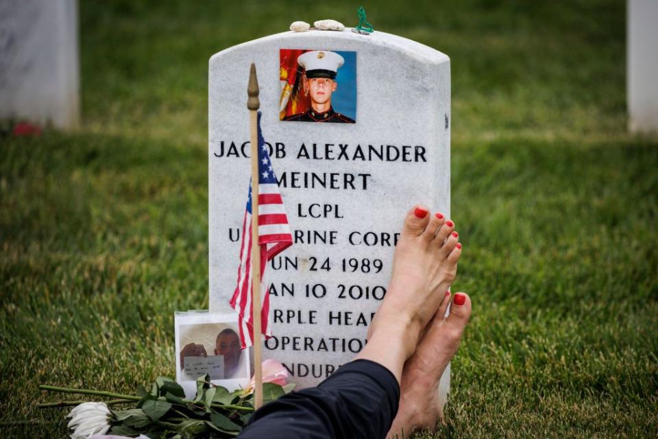 Krista Meinert sits with her son, US Marine Corps Lance Cpl. Jacob Meinert who was killed in Afghanistan in 2010, at Arlington National Cemetery on Memorial Day.