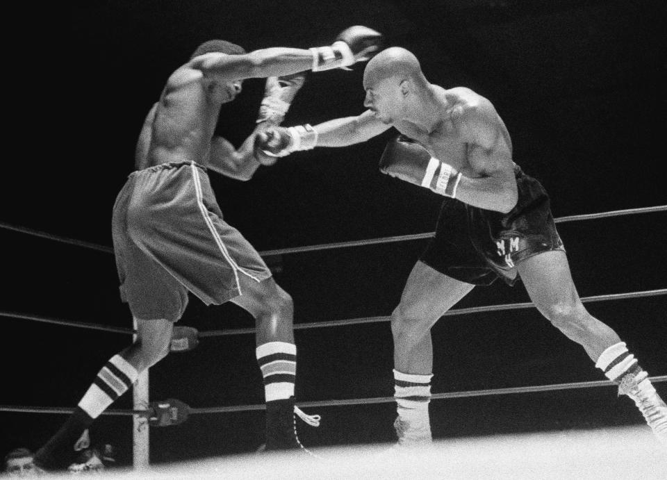 FILE - In this November 1974 file photo, Marvin Hagler, right, throws a right at Sugar Ray Seales during a boxing bout in Seattle, which ended in a draw. Hagler, the middleweight boxing great whose title reign and career ended with a split-decision loss to “Sugar” Ray Leonard in 1987, died Saturday, March 13, 2021. He was 66. (AP Photo/Barry Sweet, File)