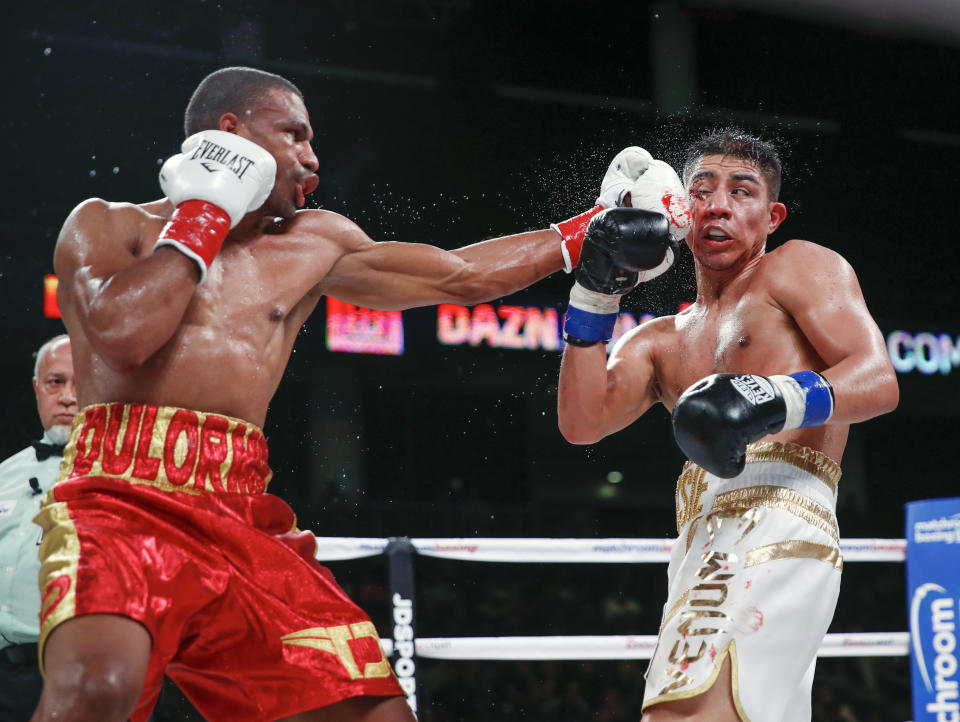Thomas Dulorme, left, hits Jessie Vargas during the WBC welterweight boxing match Saturday, Oct. 6, 2018, in Chicago. (AP Photo/Kamil Krzaczynski)