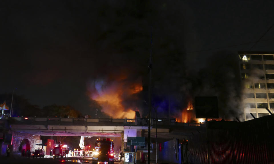 Flames rise after a fire broke out at the military-controlled Ruby Mart during a curfew in Yangon, Myanmar, early Thursday, April 1, 2021. (AP Photo)