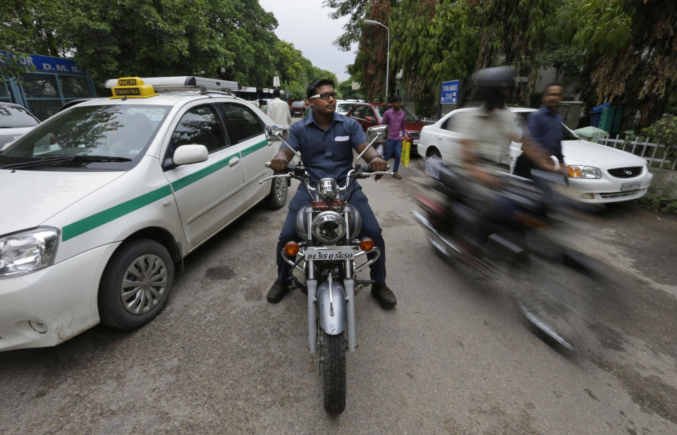 In this Tuesday, Aug. 21, 2012 photo, Pradeep Kumar rides his motorbike as he heads to work at the Deen Dayal Upadhyay Hospital in New Delhi, India. Kumar and 20 other bouncers have been hired to protect doctors as well as keep the emergency and labor rooms from filling up with patients’ often agitated relatives and friends. (AP Photo/Saurabh Das)