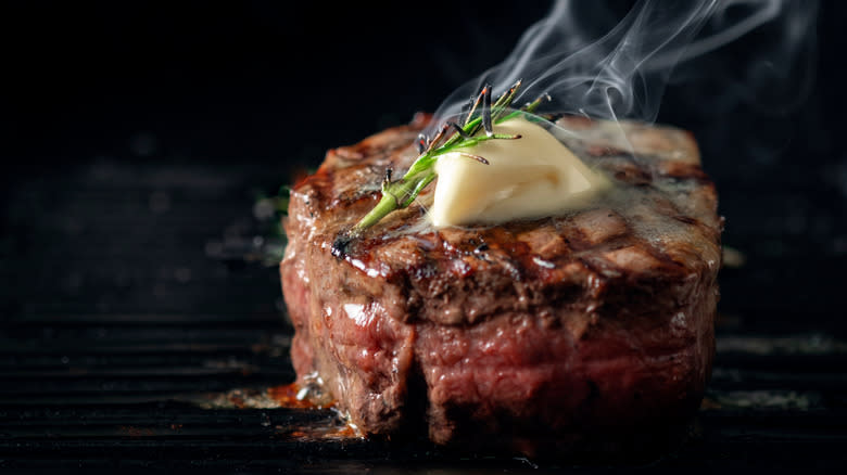 Cooked filet mignon with butter and rosemary