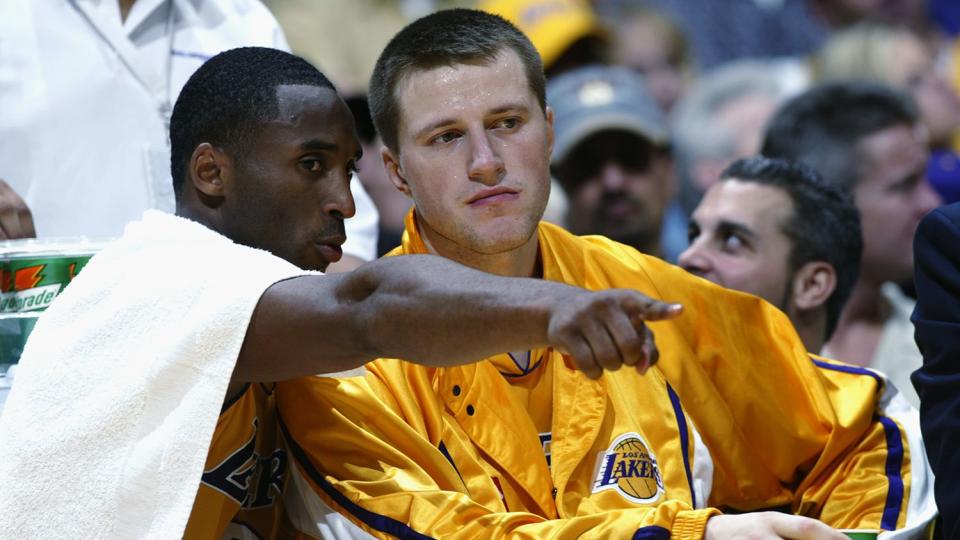 Kobe Bryant #8 talks to Stanislav Medvedenko #14 of the Los Angeles Lakers during the NBA season opener against the San Antonio Spurs at Staples Center on October 29, 2002 in Los Angeles, California. The Spurs won 87-82.