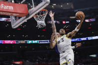 Utah Jazz guard Johnny Juzang, right, is defended by Los Angeles Clippers guard Bones Hyland during the second half of an NBA basketball game Friday, April 5, 2024, in Los Angeles. (AP Photo/Etienne Laurent)