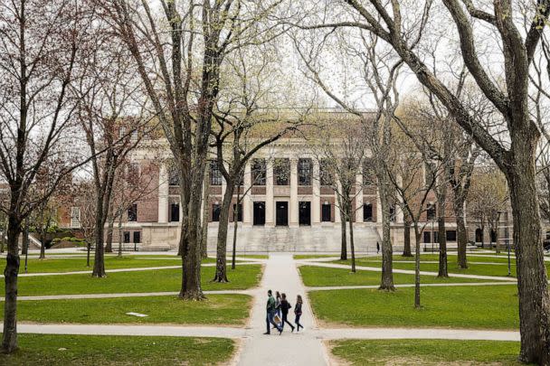 PHOTO: FILE - Pedestrians walk through Harvard Yard on the closed Harvard University campus in Cambridge, Mass., April 20, 2020. (Bloomberg via Getty Images, FILE)