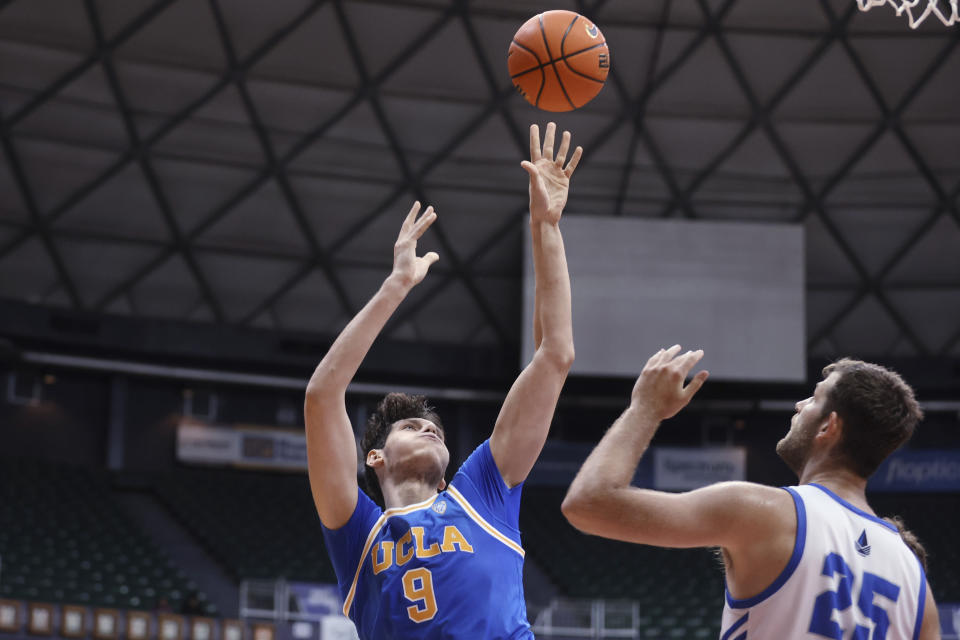 UCLA forward Berke Buyuktuncel (9) shoots over Chaminade forward Wyatt Lowell (25) during the second half of an NCAA college basketball game Tuesday, Nov. 21, 2023, in Honolulu. (AP Photo/Marco Garcia)