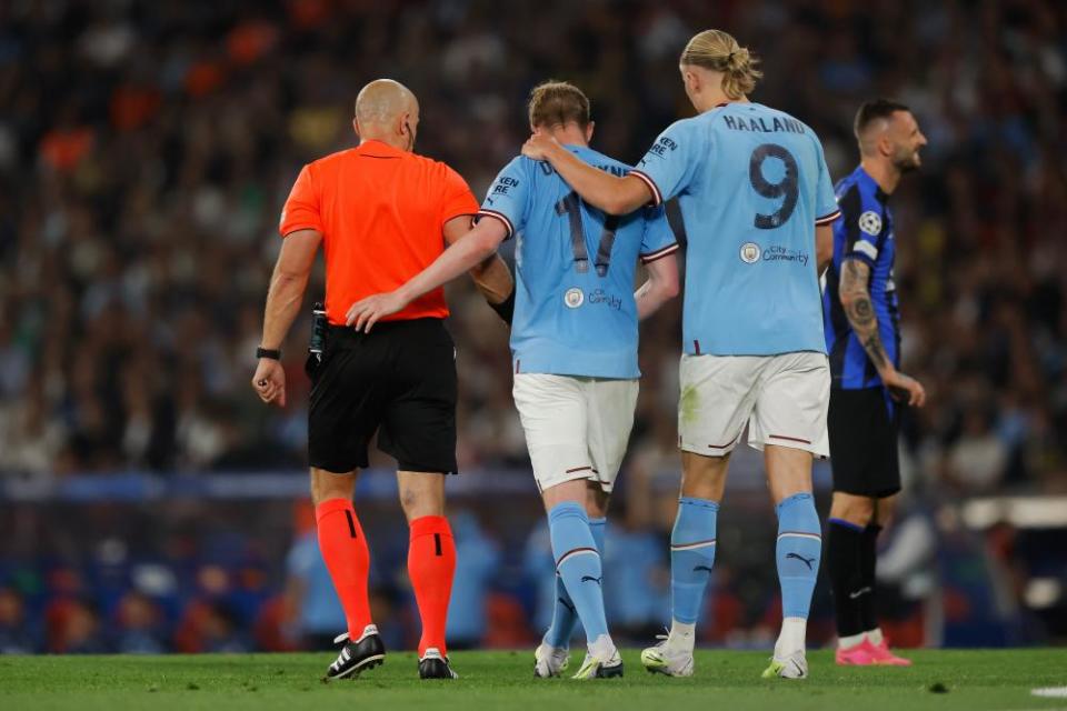 Erling Haaland consoles Kevin De Bruyne as the Belgian midfielder is forced off through injury.