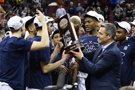 Mar 30, 2019; Louisville, KY, United States; Virginia Cavaliers head coach Tony Bennett holds the trophy during the trophy ceremony after the championship game against the Purdue Boilermakers of the south regional of the 2019 NCAA Tournament at KFC Yum Center. Mandatory Credit: Jamie Rhodes-USA TODAY Sports