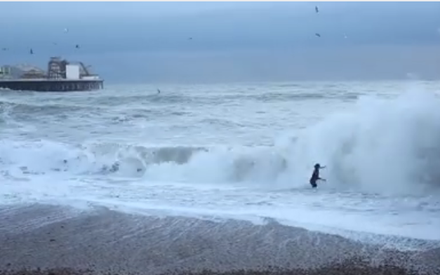 The woman can be seen running into the wall of water - Alessandro Intini/Facebook