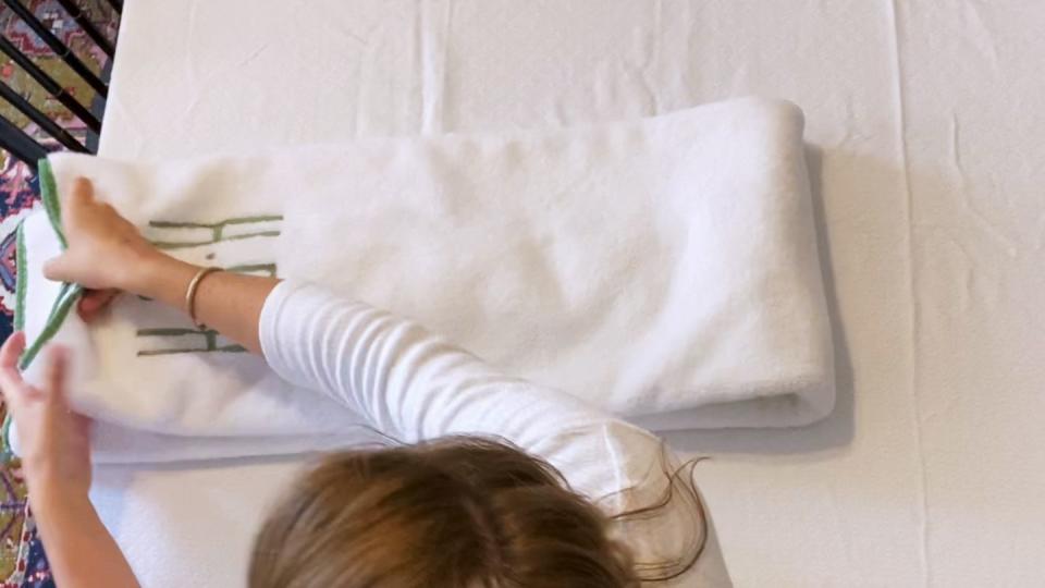 woman folding towel