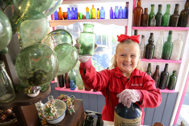 Seven-year-old schoolgirl raking in hundreds of pounds after opening antique bottle shop in her parents' back garden