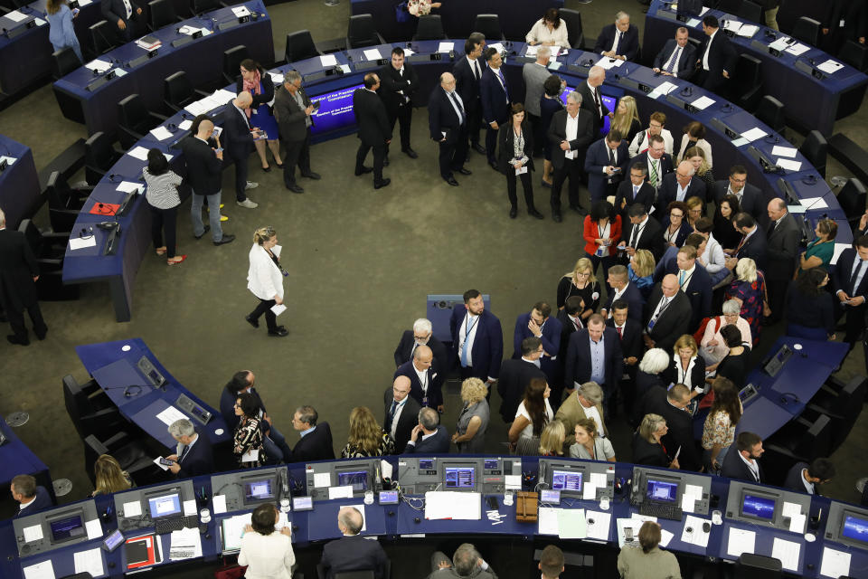 Members of the European Parliament queue to cast their ballots for the election of the German candidate Ursula von der Leyen as the new European Commission President at the European Parliament in Strasbourg, eastern France, Tuesday, July 16, 2019. (AP Photo/Jean-Francois Badias)