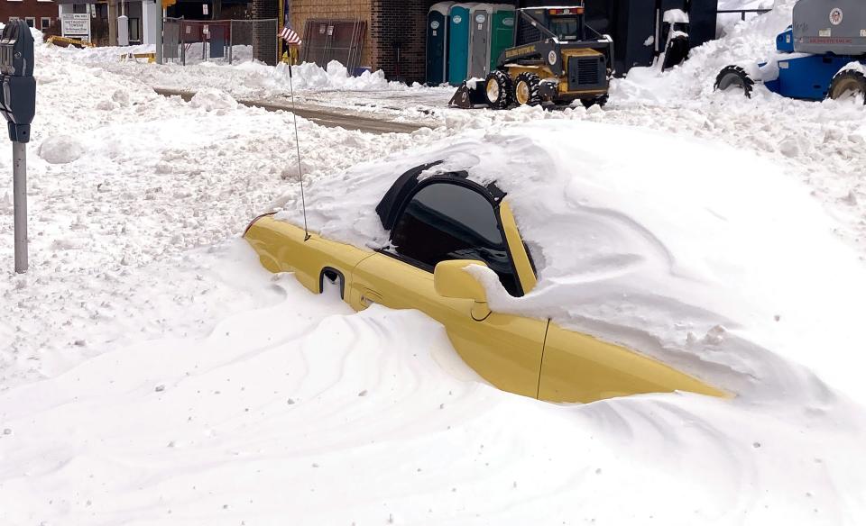Vehicles throughout the city of Erie were buried in snow after the storm that hit Sunday and Monday, dumping nearly 2 feet of snow in some areas. This car was parked on Sassafras Street, near West Ninth Street, on Tuesday.